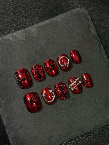Red press-on nails with studs, inspired by "Nine Vicious"